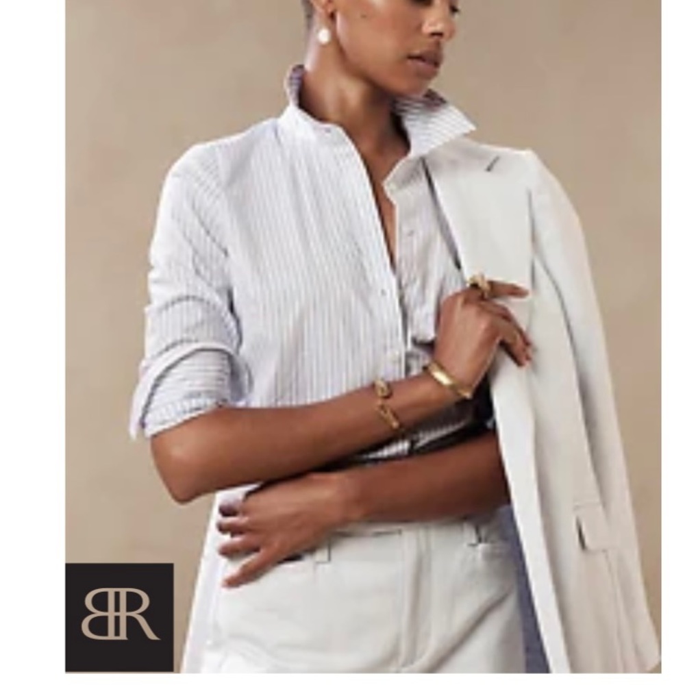 Point collar• Buttoned cuffs• Angled bust darts